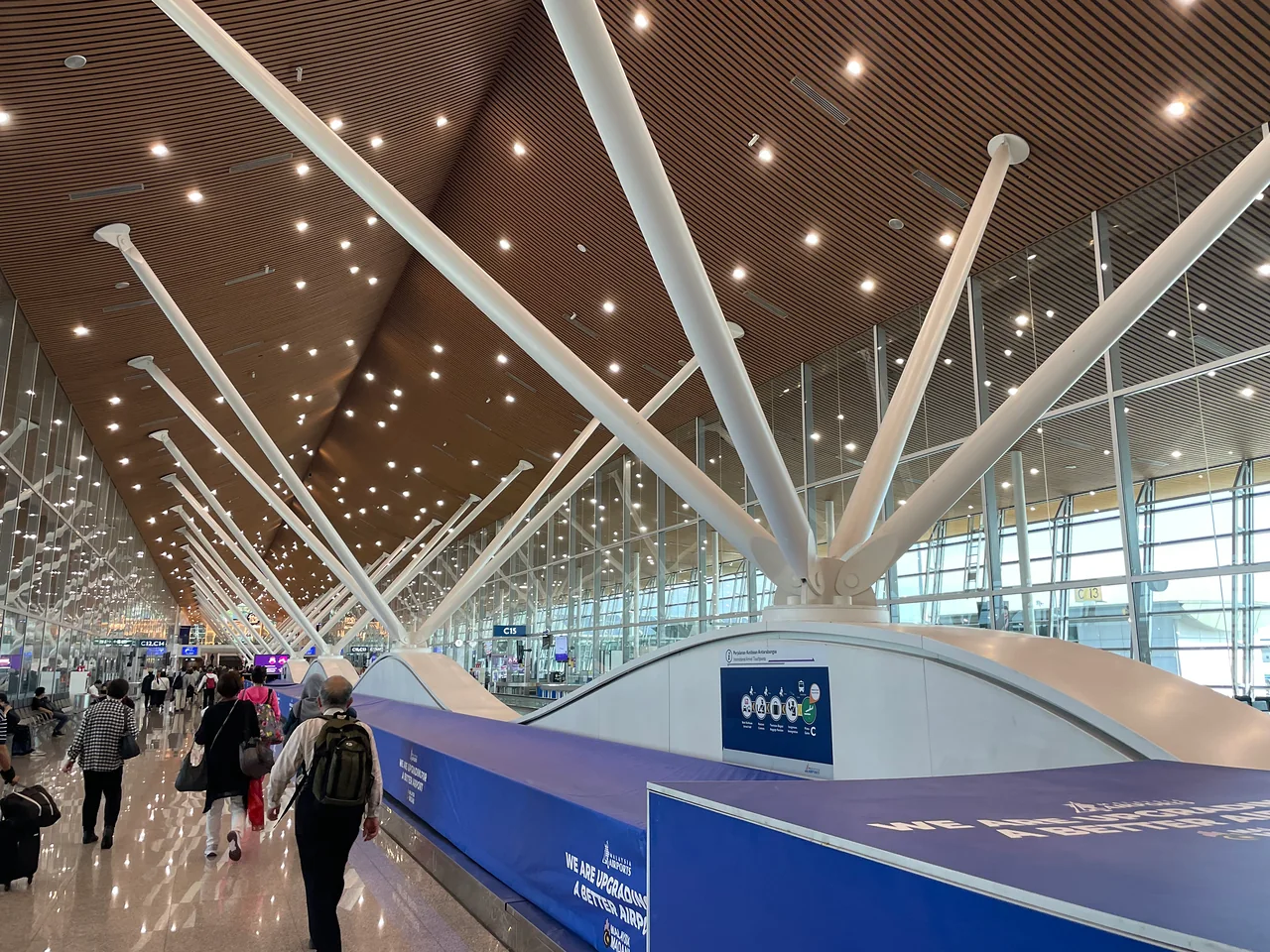 The concourse of Kuala Lumpur International Airport under its lit canopy